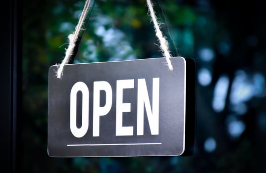 A shop label Open which hanging on the glass door of the shop, concept for informing people in Covid19 crisis situations around the world. photo
