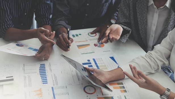 Group of business people meeting together Pointing to the graph assess business profits. photo