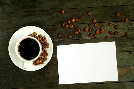 a cup of coffee with coffee beans on wooden table.Flatlay, mock up. photo