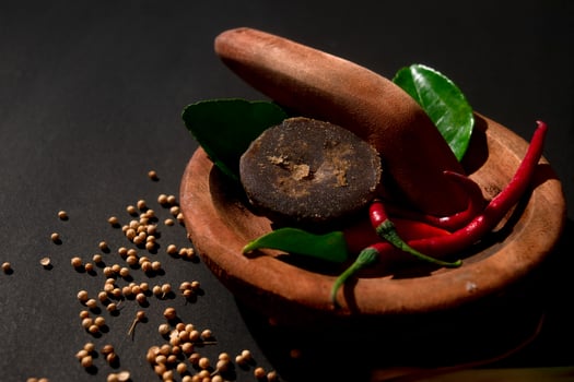 wooden mortar and pestle with herbs. suitable for traditional food campaign photo