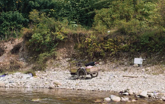 Old pedicab on the edge of the river photo