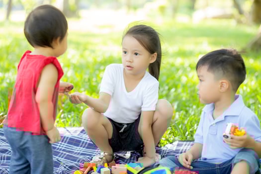 Little boy and girl is playing for idea and inspiration with toy block, kid learning with construction block for education, child activity and game in the park with happy in the summer. photo