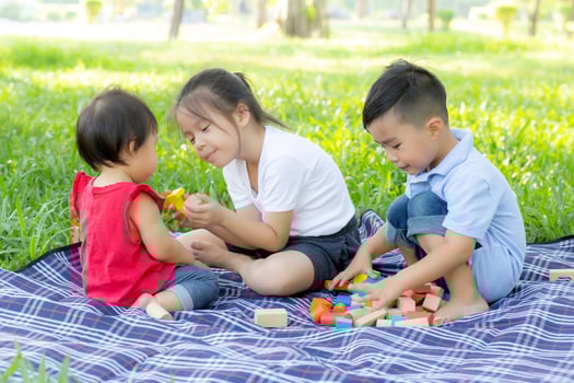Little boy and girl is playing for idea and inspiration with toy block, kid learning with construction block for education, child activity and game in the park with happy in the summer. photo