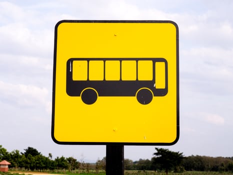 Bus stop sign in rural road photo
