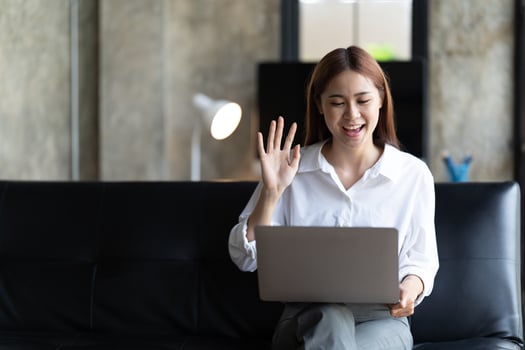 asian young woman has video chat with friends with webcam, Happy young asian business woman waving hands to greeting partner during making video conference with her team. photo