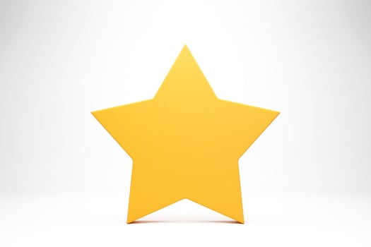 Big yellow shiny star with soft shadow on white background . photo