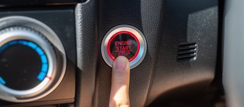 Finger press a car ignition button or START engine inside modern electric automobile. Keyless, change, strategy, vision, innovation and future concept photo