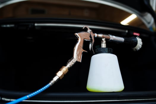 Spray container or washing bottle liquid for car cleaning. photo