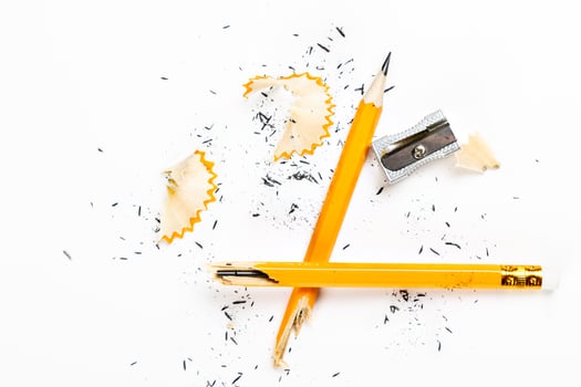 Pencil, metal sharpener and pencil shavings on white background. Horizontal image. photo