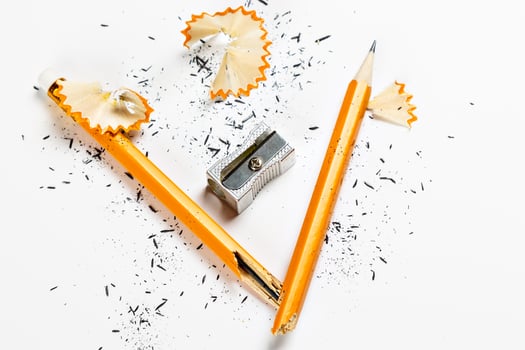 Pencil, metal sharpener and pencil shavings on white background. Horizontal image. photo