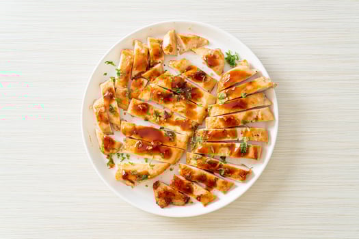 grilled chicken breast sliced on plate photo