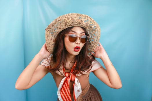 Young Asian woman shocked and isolated by a blue background. photo