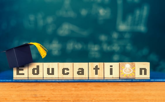 Cubes with word education and graduation hat on cubes ,education concept photo