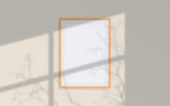 Clean and minimalist front view portrait wooden photo or poster frame mockup hanging on the wall with shadow overlay. 3d rendering.