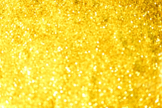 Golden glitter bokeh lighting texture Blurred abstract background for birthday, anniversary, wedding, new year eve or Christmas photo