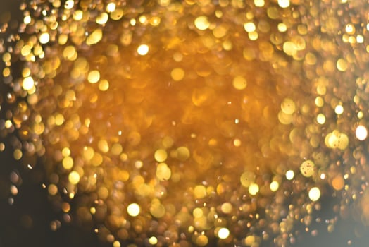 Golden glitter bokeh lighting texture Blurred abstract background for birthday, anniversary, wedding, new year eve or Christmas photo