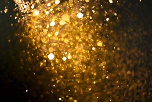 Golden glitter bokeh lighting texture Blurred abstract background for birthday, anniversary, wedding, new year eve or Christmas photo