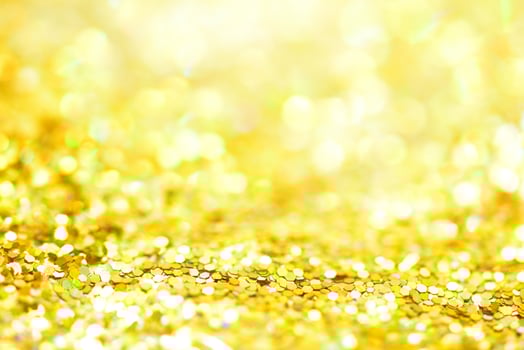 Golden glitter bokeh lighting texture Blurred abstract background for birthday, anniversary, wedding, new year eve or Christmas photo