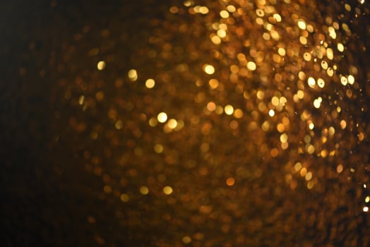 Golden glitter bokeh lighting texture Blurred abstract background for birthday, anniversary, wedding, new year eve or Christmas photo