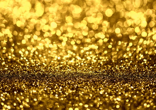 Golden glitter bokeh lighting texture Blurred abstract background for birthday, anniversary, wedding, new year eve or Christmas photo