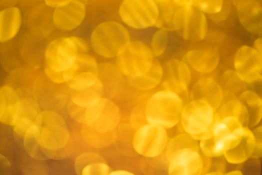 Golden glitter bokeh lighting texture Blurred abstract background for birthday, anniversary, wedding, new year eve or Christmas photo