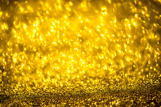 Golden glitter bokeh lighting texture Blurred abstract background for birthday, anniversary, wedding, new year eve or Christmas photo