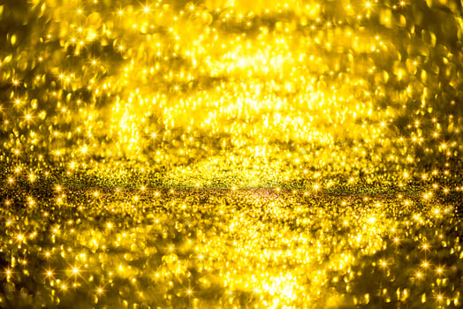 Golden glitter bokeh lighting texture Blurred abstract background for birthday, anniversary, wedding, new year eve or Christmas photo