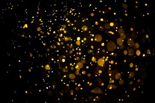 Golden glitter bokeh lighting texture Blurred abstract background for birthday, anniversary, wedding, new year eve or Christmas photo