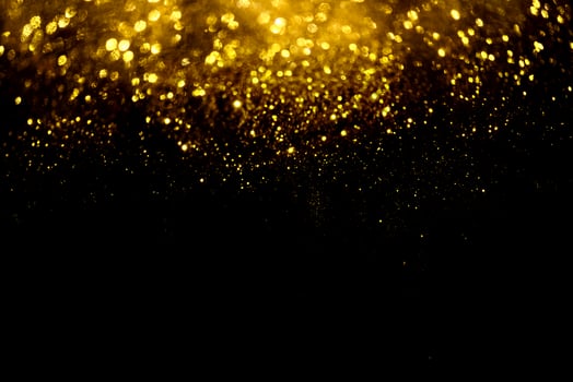 Golden glitter bokeh lighting texture Blurred abstract background for birthday, anniversary, wedding, new year eve or Christmas photo