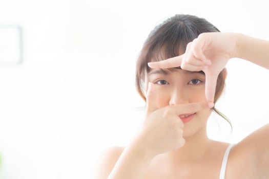 Beautiful young asian woman eye skin care and gesture frame with hand for vision, beauty asia girl face cosmetic and makeup for health, eyesight of female for wellness with freshness. photo