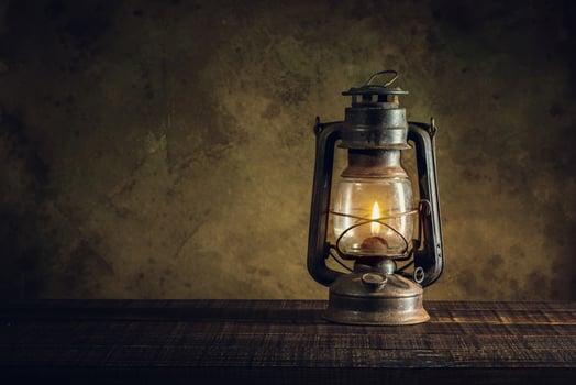 kerosene lamp oil lantern burning with glow soft light on aged wood floor photo