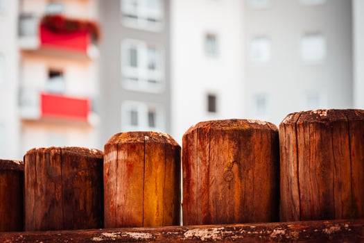 a wooden fence in front of a skyscraper photo