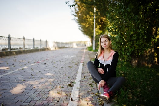 Young girl has the training and doing exercise outdoors. Sport, fitness, street workout concept. photo