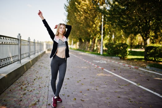Young girl has the training and doing exercise outdoors. Sport, fitness, street workout concept. photo