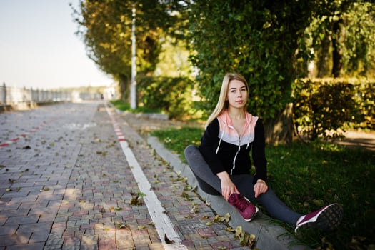 Young girl has the training and doing exercise outdoors. Sport, fitness, street workout concept. photo
