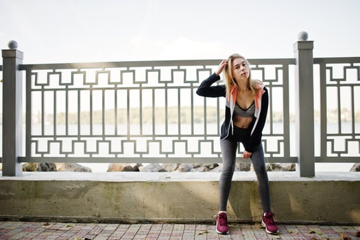 Young girl has the training and doing exercise outdoors. Sport, fitness, street workout concept. photo