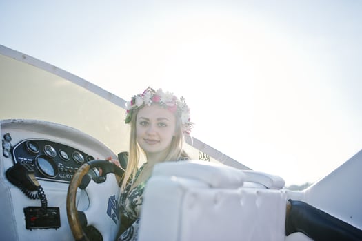 Blonde girl in wreath sitting on yacht at hen party. photo