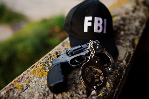 FBI cap with revolver and handcuff. photo