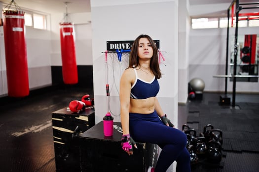 Young beautiful woman doing exercises  and working hard in gym and enjoying her training process. photo