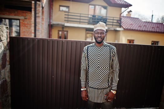 Portrait of stylish black african american man at hat and sunglasses against fence. photo