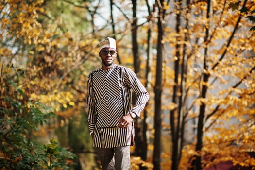 Portrait of stylish black african american man at hat and sunglasses against sunny autumn fall background. photo