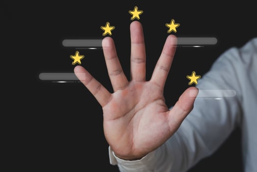 Customer review concept. Around the hands, there are five stars. There are boxes for text. Close up shot isolated on black background. photo