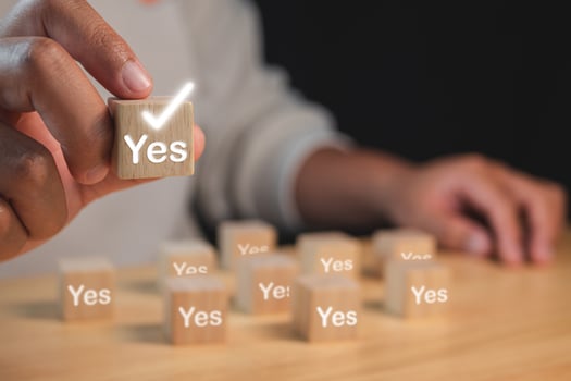 Evaluation and decision concept. Correct or Yes or True symbols. Man holds a wood block with copy space. photo