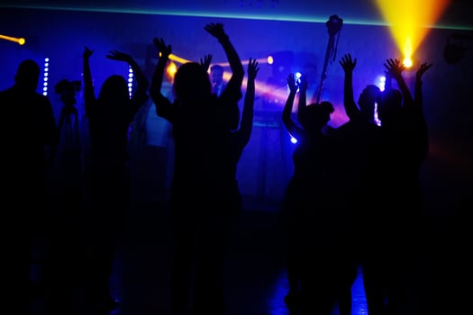 Musicial music live band performing on a stage with different lights with crowd of people fans. photo