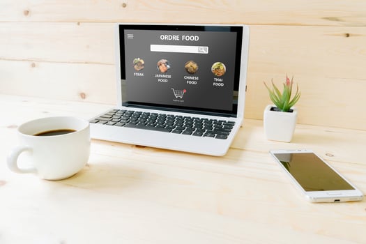 Order food online search engine on laptop  on wood table photo