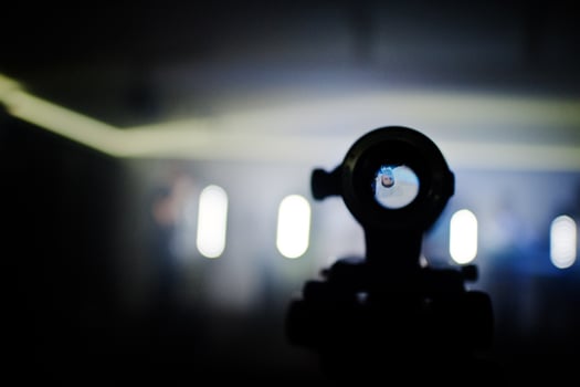 Professional video camera lens on tripod background people on stage. photo