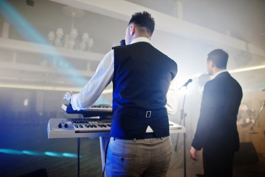 Musicial music live band performing on a stage with different lights. Keyboardist play. photo