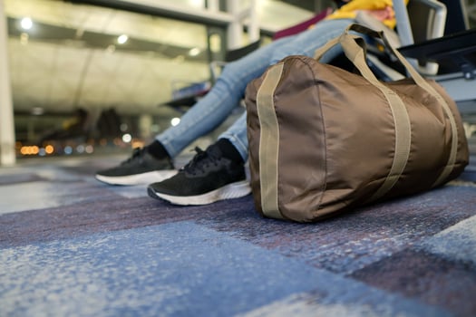 Young woman at international airport, waiting for her flight. photo