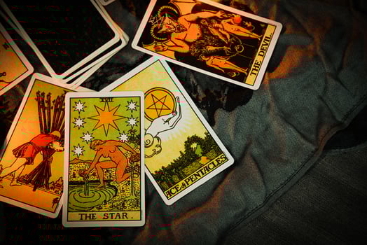 Tarot reading with tarot card background and candlelight on the table for Astrology Occult Magic Spiritual Horoscopes and Palm reading fortune teller tarot reader photo