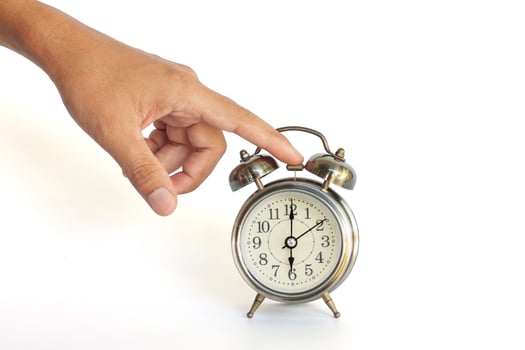 Hand of men turning off the alarm clock isolated on white background included clipping path. photo